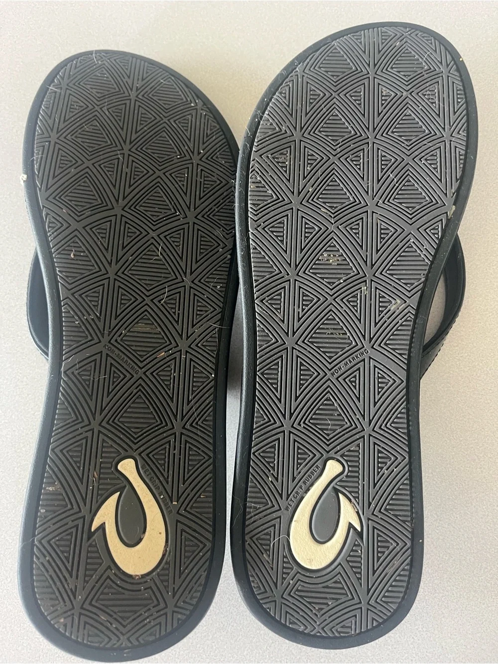 Olukai black flip flops.